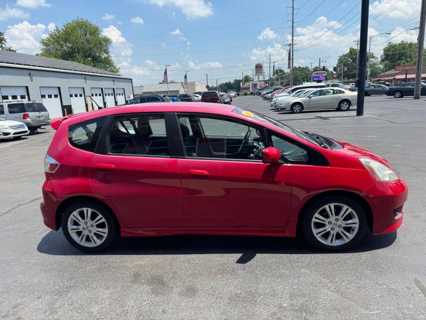 2009 RED HONDA FIT SPORT (JHMGE88449C) with an 1.5L engine, Automatic transmission, located at 3100 Covert Avenue, Evansville, IN, 47714, (812) 473-4492, 37.955418, -87.512238 - Photo#2