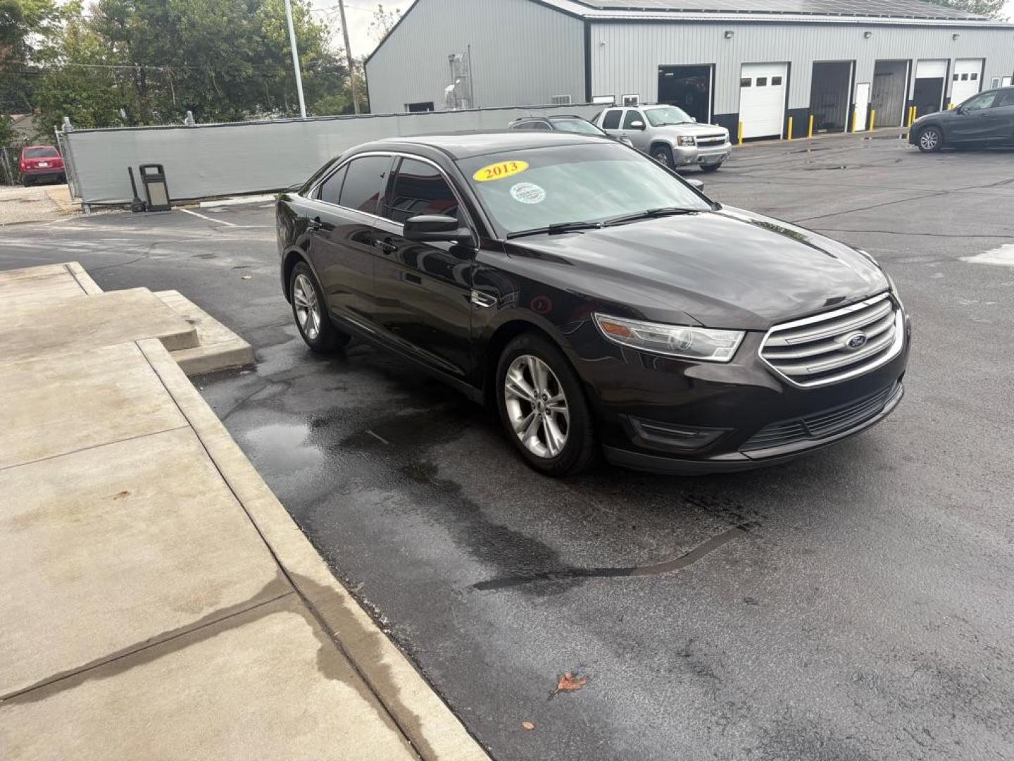 2013 BLACK FORD TAURUS SEL (1FAHP2E82DG) with an 3.5L engine, Automatic transmission, located at 3100 Covert Avenue, Evansville, IN, 47714, (812) 473-4492, 37.955418, -87.512238 - Photo#2