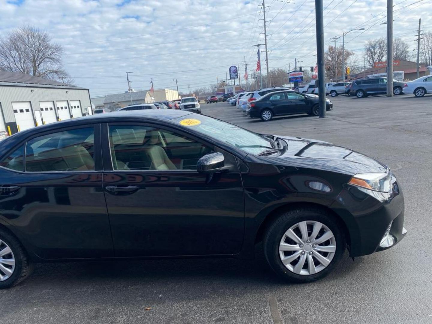 2015 BLACK TOYOTA COROLLA L (5YFBURHE6FP) with an 1.8L engine, Automatic transmission, located at 3100 Covert Avenue, Evansville, IN, 47714, (812) 473-4492, 37.955418, -87.512238 - Photo#2